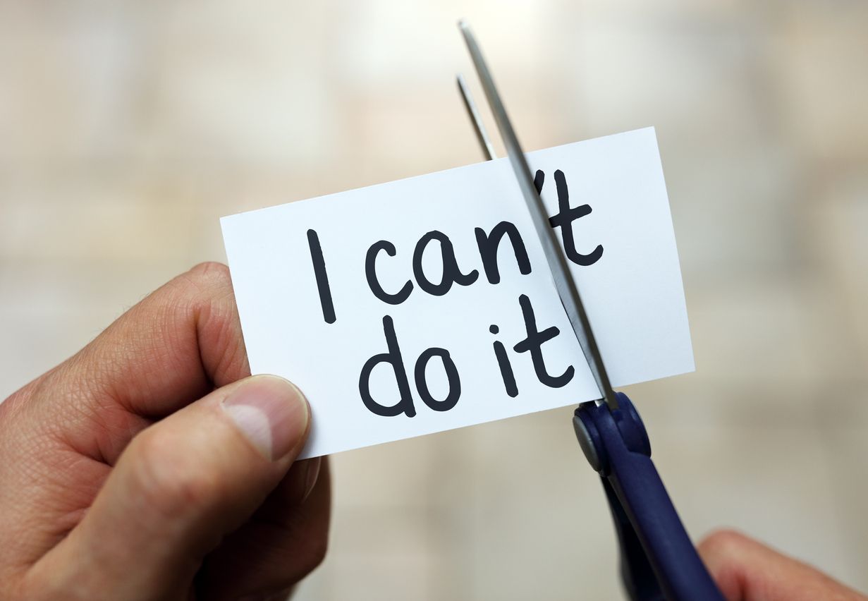 scissors cutting the "'t" from the text "I can't do it"
