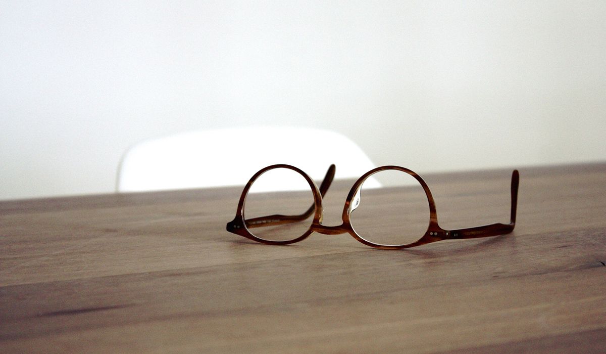 pair of glasses lying on a table